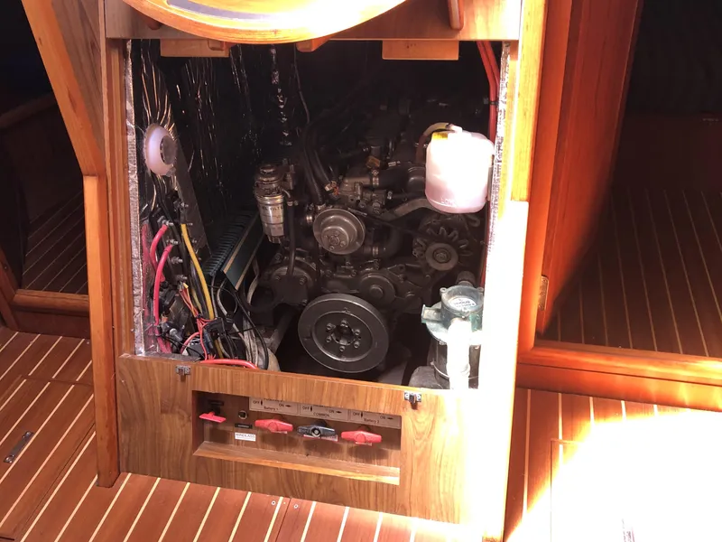 Slide: The Image of Engine compartment of a 2001 Jeanneau 45.2 sailboat, showcasing mechanical components and wiring. - 21