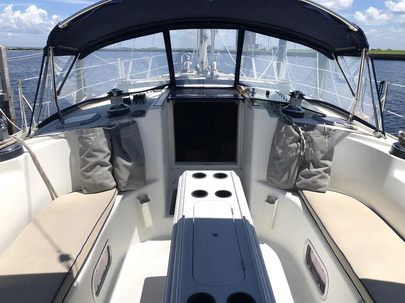 Slide: The Image of Jeanneau 45.2 sailboat cockpit, 2001 model, with seating and canopy, on open water. - 4