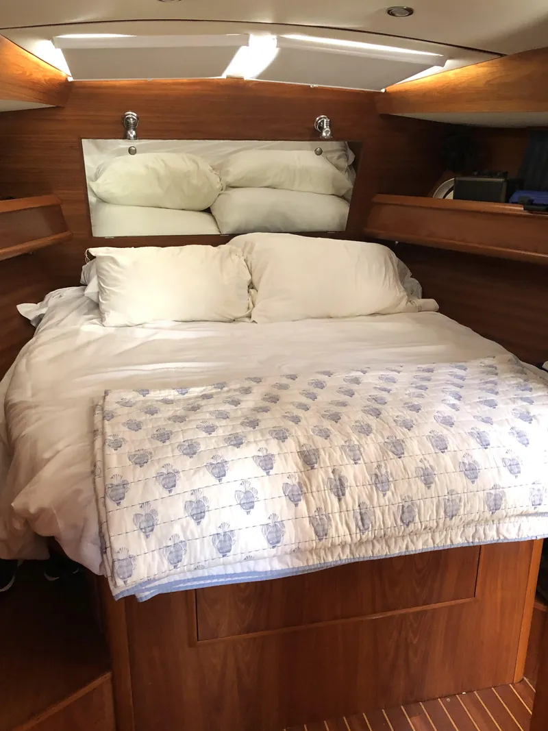 Slide: The Image of Cozy cabin interior of 2001 Jeanneau 45.2 sailboat with wooden finish and comfortable bedding. - 6