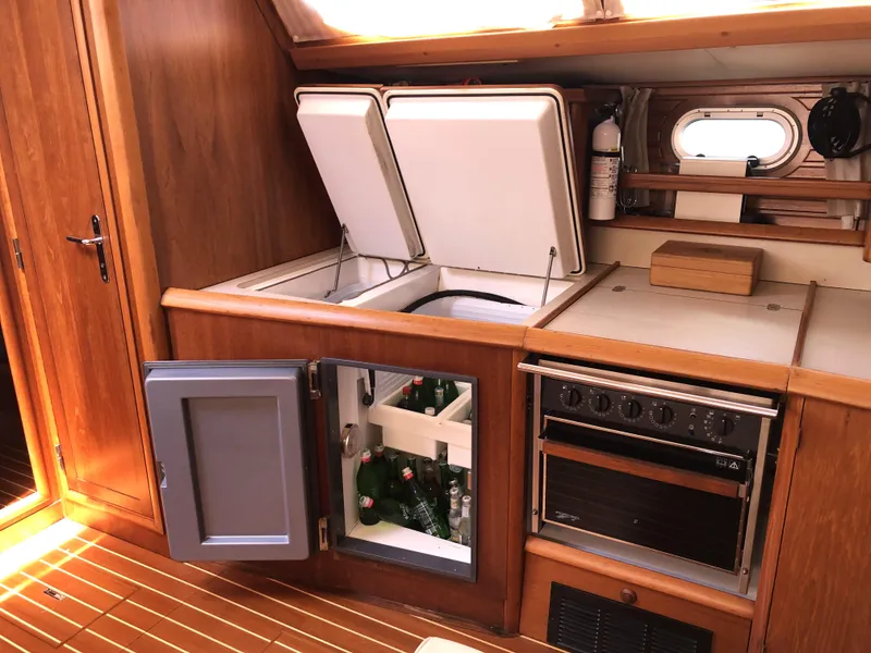 Slide: The Image of Interior of 2001 Jeanneau 45.2 yacht kitchen with fridge, stove, and wooden cabinetry. - 8