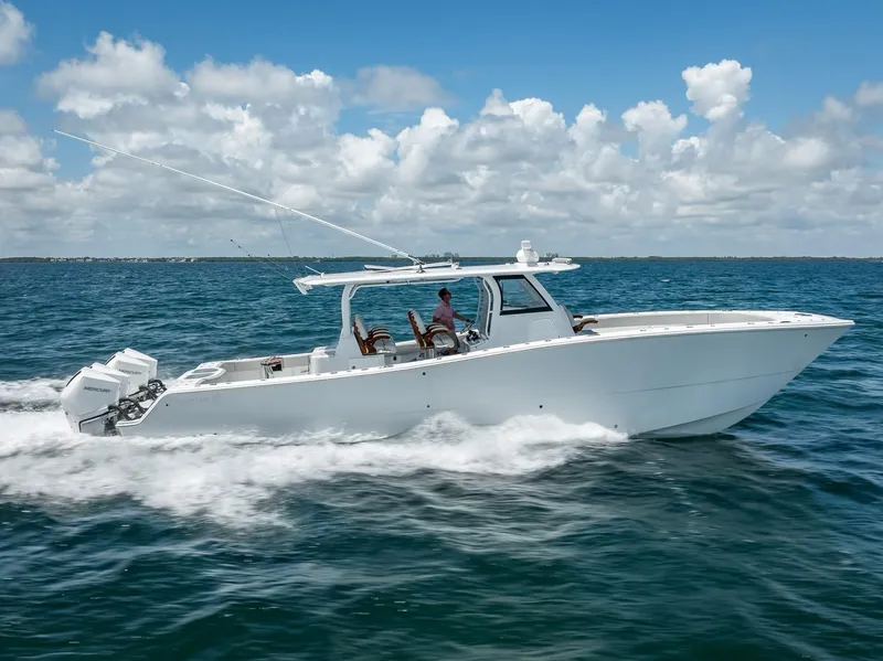 Slide: The Image of Freeman 43 boat cruising on open water, 2023 model, under a clear blue sky. - 0