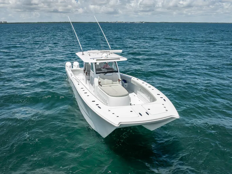 Slide: The Image of Freeman 43 boat, 2023 model, cruising on open ocean under cloudy sky. - 12