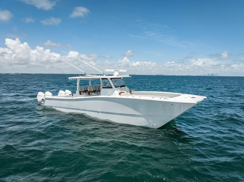 Slide: The Image of 2023 Freeman 43 boat cruising on open water under a clear blue sky. - 14