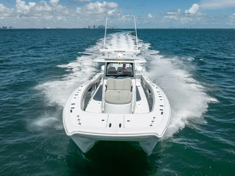 Slide: The Image of Freeman 43 boat cruising on open water, 2023 model, clear sky background. - 2