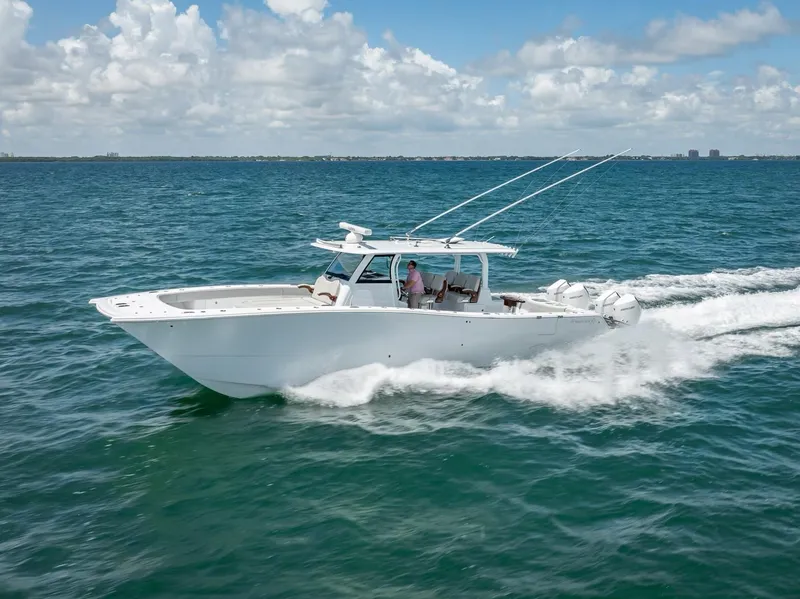 Slide: The Image of 2023 Freeman 43 boat cruising on open water under a clear sky. - 3