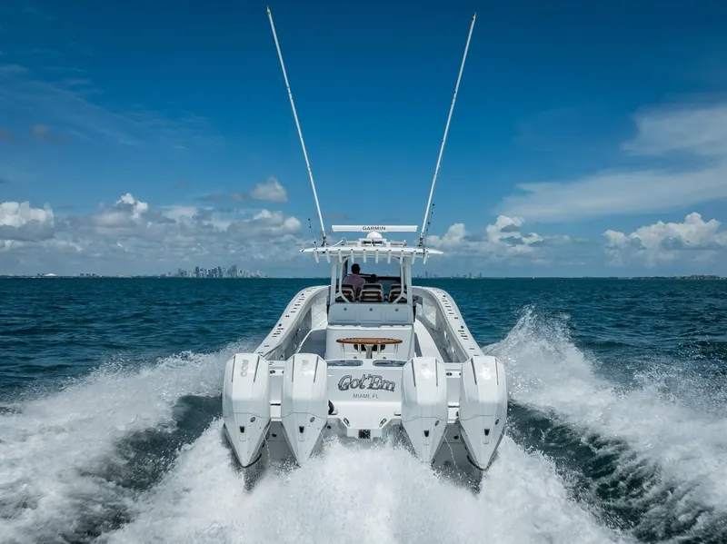 Slide: The Image of 2023 Freeman 43 boat speeding on open water with city skyline in background. - 4