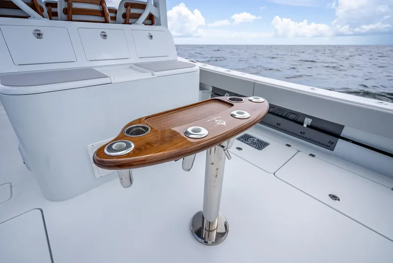 Slide: The Image of Freeman 43 boat deck with wooden table, ocean view, 2023 model. - 43