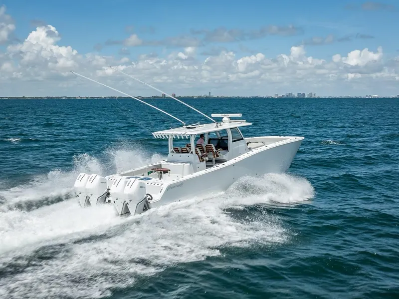 Slide: The Image of Freeman 43 boat cruising on open sea, 2023 model, under clear blue sky. - 6