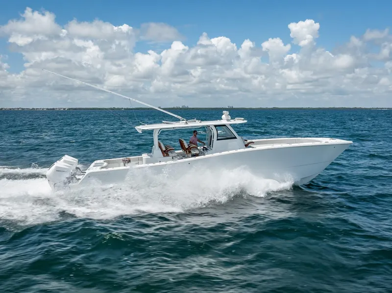 Slide: The Image of 2023 Freeman 43 boat cruising on open sea under blue sky. - 7