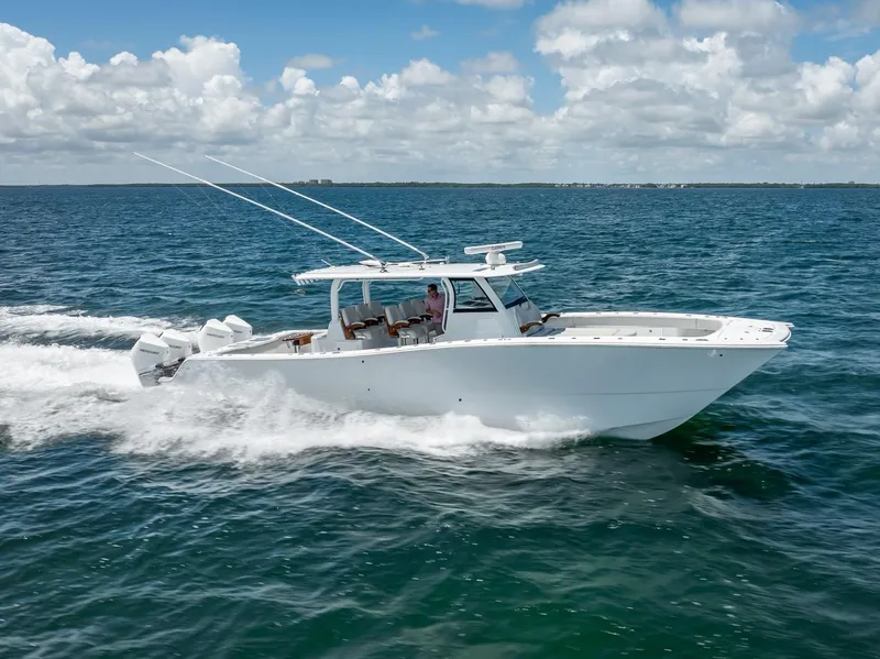 Slide: The Image of Freeman 43 boat cruising on open water, 2023 model, under a clear blue sky. - 8