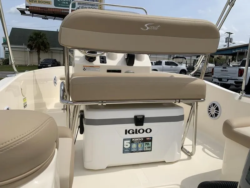 Slide: The Image of 2025 Scout 175 Sportfish boat interior with Igloo cooler and beige seating. - 10