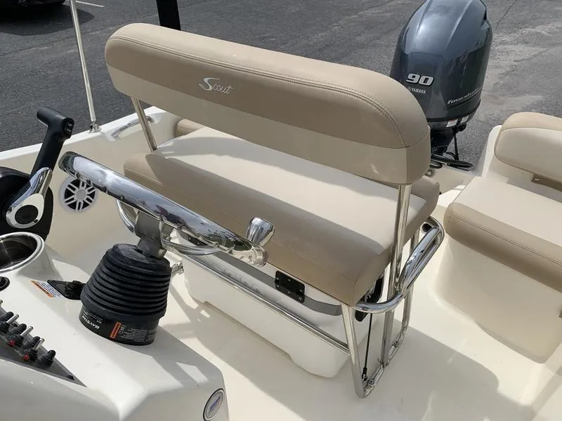Slide: The Image of 2025 Scout 175 Sportfish boat interior with beige seating and Yamaha 90 outboard motor. - 11