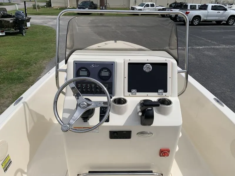 Slide: The Image of 2025 Scout 175 Sportfish boat dashboard with steering wheel and controls. - 12