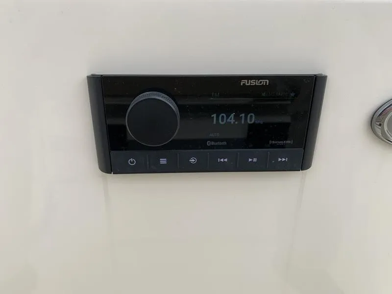 Slide: The Image of Fusion marine stereo system on 2025 Scout 175 Sportfish boat dashboard. - 14