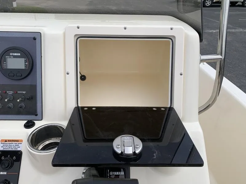 Slide: The Image of 2025 Scout 175 Sportfish console with Yamaha controls and storage compartment. - 15