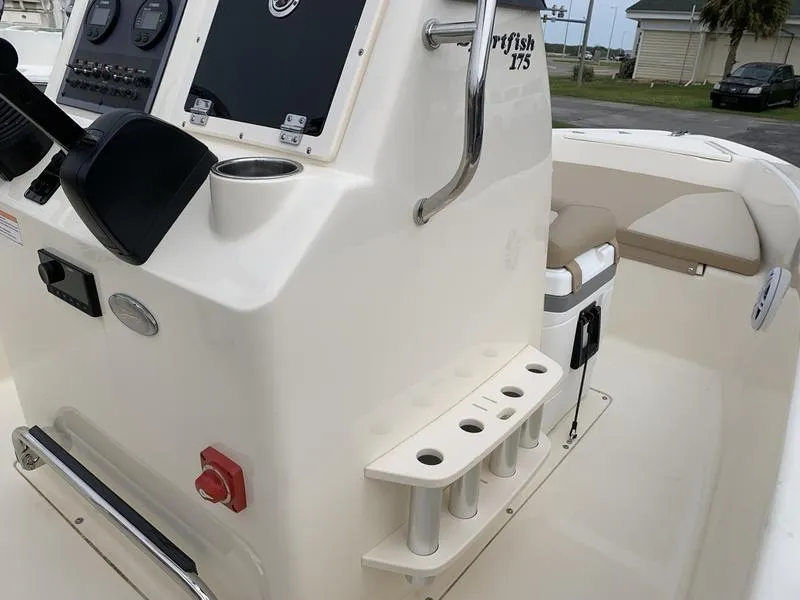 Slide: The Image of 2025 Scout 175 Sportfish boat console with rod holders and seating. - 16