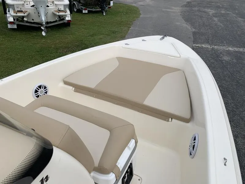 Slide: The Image of 2025 Scout 175 Sportfish boat interior with beige seating and speakers. - 17