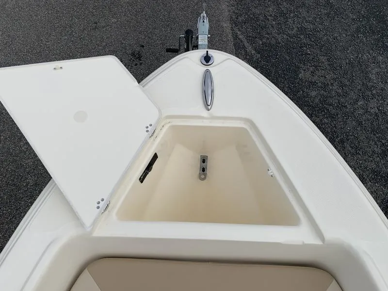 Slide: The Image of 2025 Scout 175 Sportfish boat with open storage compartment on deck. - 19