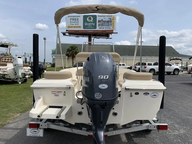 Slide: The Image of 2025 Scout 175 Sportfish boat with Yamaha 90 engine, parked outdoors. - 2