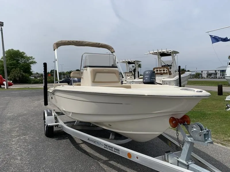 Slide: The Image of 2025 Scout 175 Sportfish boat on trailer, parked outdoors. - 5