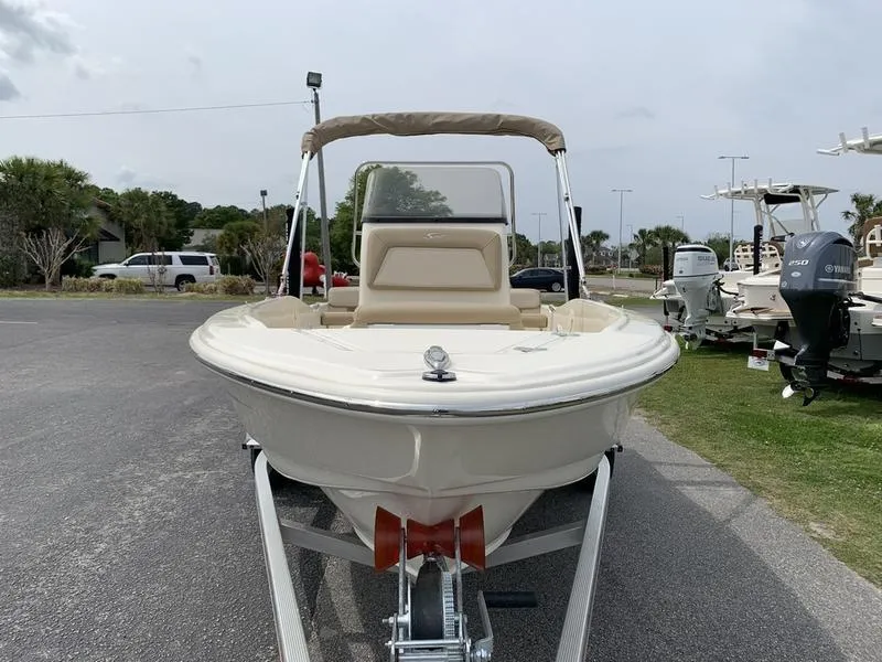 Slide: The Image of 2025 Scout 175 Sportfish boat on trailer, parked outdoors, front view. - 6