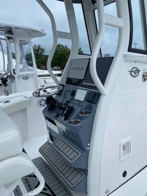 Slide: The Image of 2026 Tidewater 232cc/LXF boat console with Garmin navigation, sleek design, and modern controls. - 7