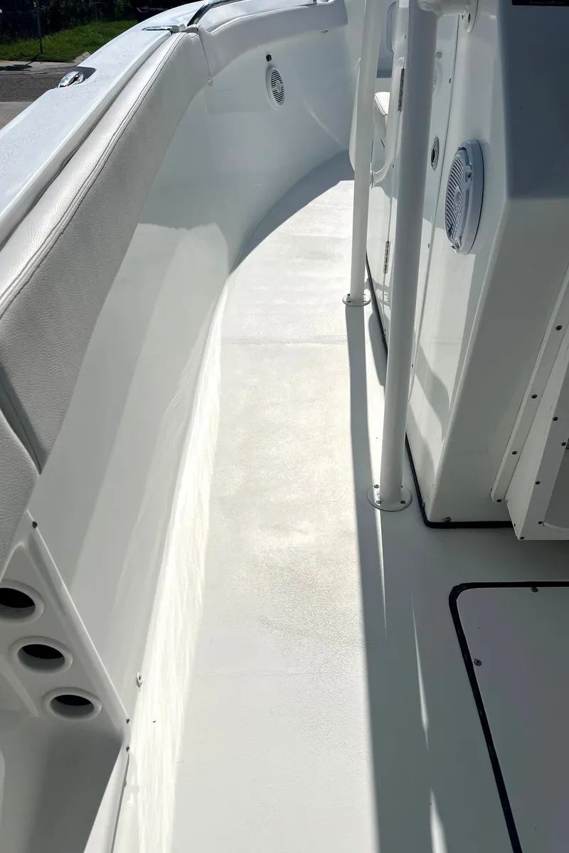 Slide: The Image of 2018 Clearwater 2508 boat interior, featuring sleek white deck and side panel design. - 13