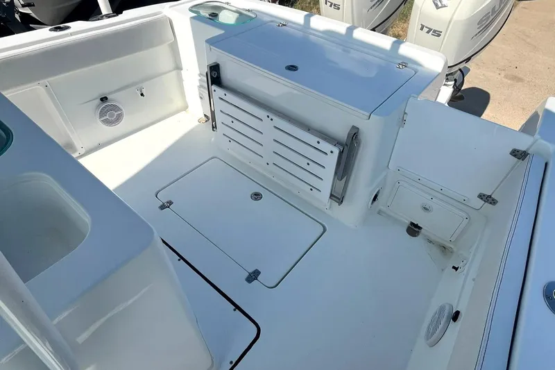 Slide: The Image of 2018 Clearwater 2508 boat deck with storage compartments and clean white finish. - 16