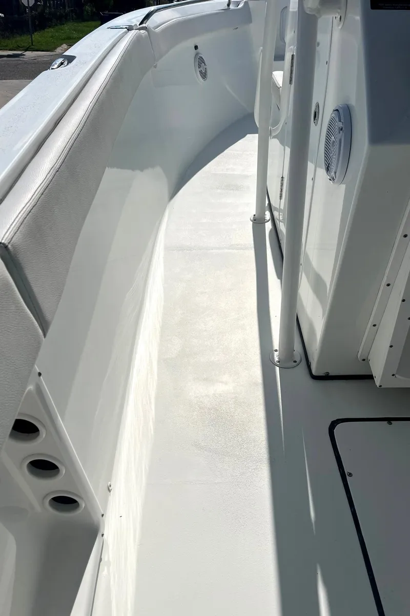 Slide: The Image of 2018 Clearwater 2508 boat interior, featuring sleek white deck and side panel details. - 14