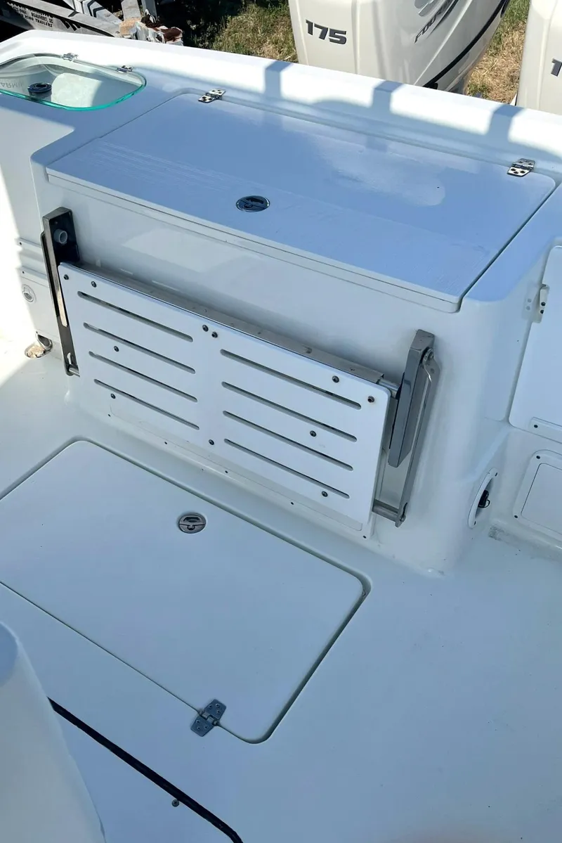 Slide: The Image of 2018 Clearwater 2508 boat interior with storage compartments and seating. - 15
