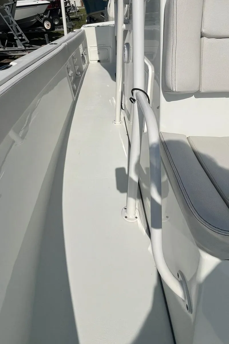 Slide: The Image of 2018 Clearwater 2508 boat interior with white seating and sleek design. - 9