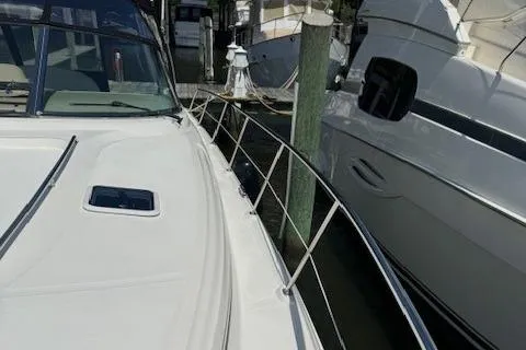 Slide: The Image of 2002 Sea Ray 410 Sundancer docked at marina, side view. - 10