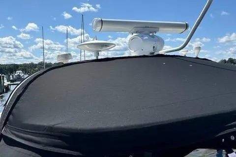 Slide: The Image of 2002 Sea Ray 410 Sundancer boat with radar equipment under a clear blue sky. - 11