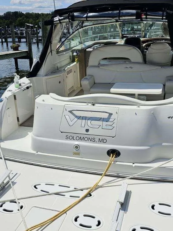 Slide: The Image of 2002 Sea Ray 410 Sundancer docked in Solomons, MD, with spacious seating and sleek design. - 14