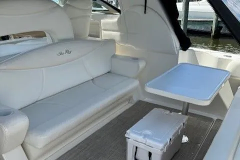 Slide: The Image of Interior of 2002 Sea Ray 410 Sundancer with white seating and table. - 22
