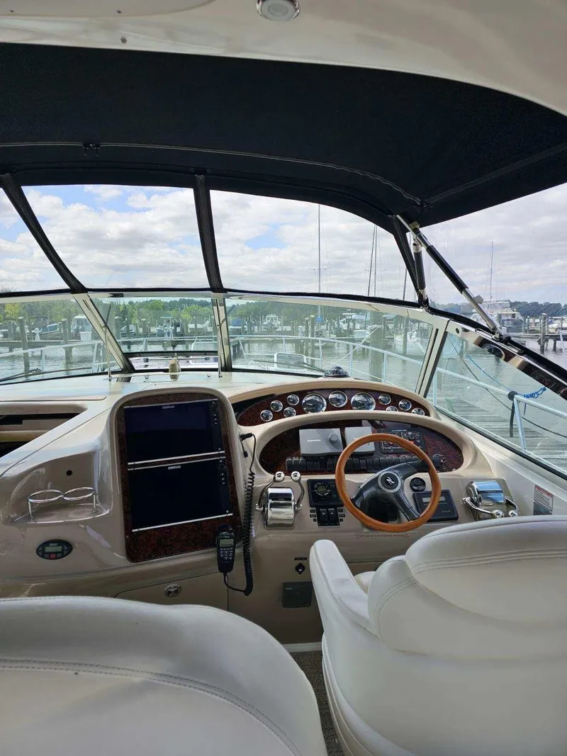 Slide: The Image of Interior view of 2002 Sea Ray 410 Sundancer yacht cockpit with steering wheel and controls. - 24