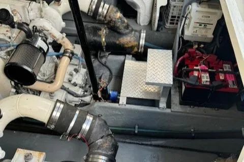 Slide: The Image of Engine room of 2002 Sea Ray 410 Sundancer with visible components and battery. - 31