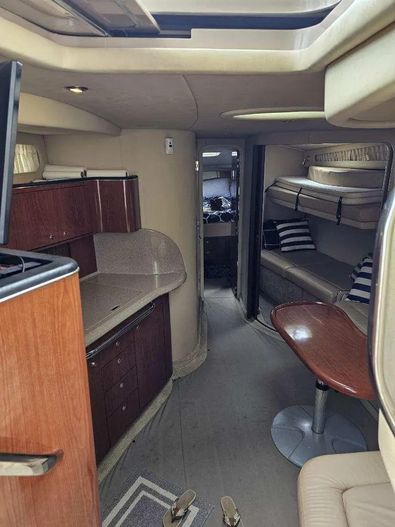 Slide: The Image of Interior of 2002 Sea Ray 410 Sundancer yacht with modern amenities and cozy seating. - 36