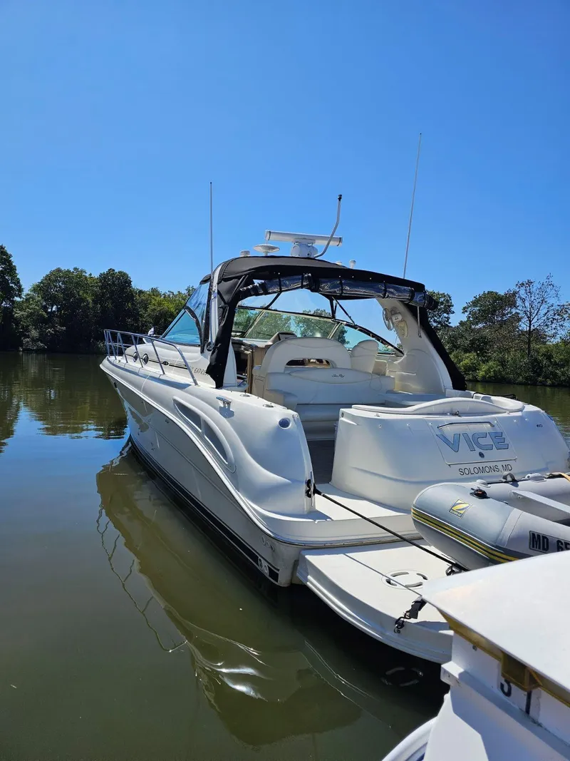 Slide: The Image of 2002 Sea Ray 410 Sundancer yacht on calm water, clear blue sky. - 4