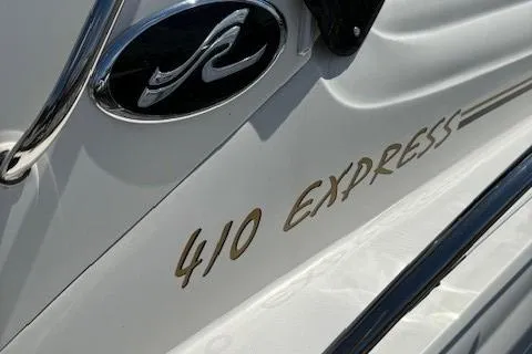 Slide: The Image of Close-up of 2002 Sea Ray 410 Sundancer boat logo and model name. - 7