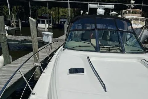 Slide: The Image of 2002 Sea Ray 410 Sundancer docked at marina, front view. - 9