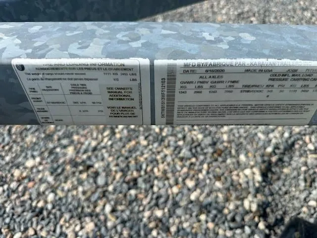 Slide: The Image of Close-up of Yamaha WaveRunner VX Limited 2021 label on a gravel surface. - 11