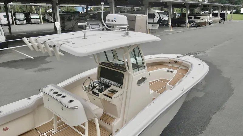 Slide: The Image of 2009 Scout 282 Sportfish boat with center console and Garmin equipment in a parking area. - 10