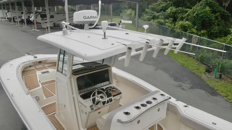 Slide: The Image of 2009 Scout 282 Sportfish boat with Garmin equipment, docked near greenery. - 11