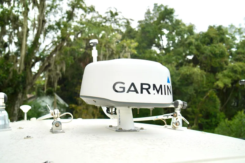 Slide: The Image of Garmin radar on 2009 Scout 282 Sportfish boat, surrounded by lush greenery. - 13