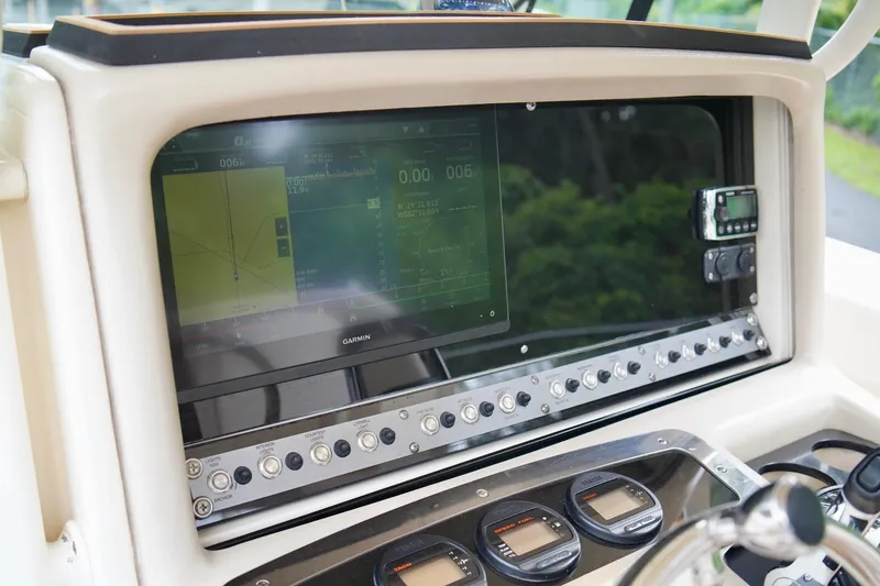 Slide: The Image of Dashboard of a 2009 Scout 282 Sportfish boat with navigation controls. - 15