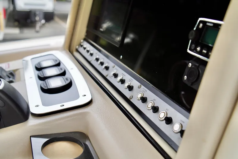 Slide: The Image of Close-up of 2009 Scout 282 Sportfish boat dashboard with controls and switches. - 16