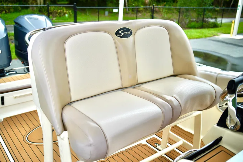 Slide: The Image of 2009 Scout 282 Sportfish boat seat with beige upholstery and logo. - 17