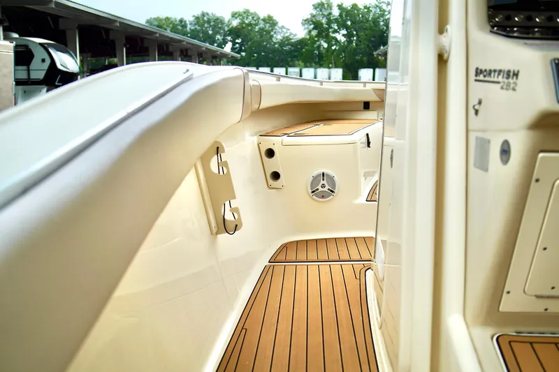 Slide: The Image of 2009 Scout 282 Sportfish boat interior with teak flooring and speaker. - 18