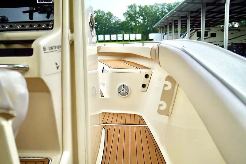 Slide: The Image of 2009 Scout 282 Sportfish boat interior with teak flooring and speaker. - 19
